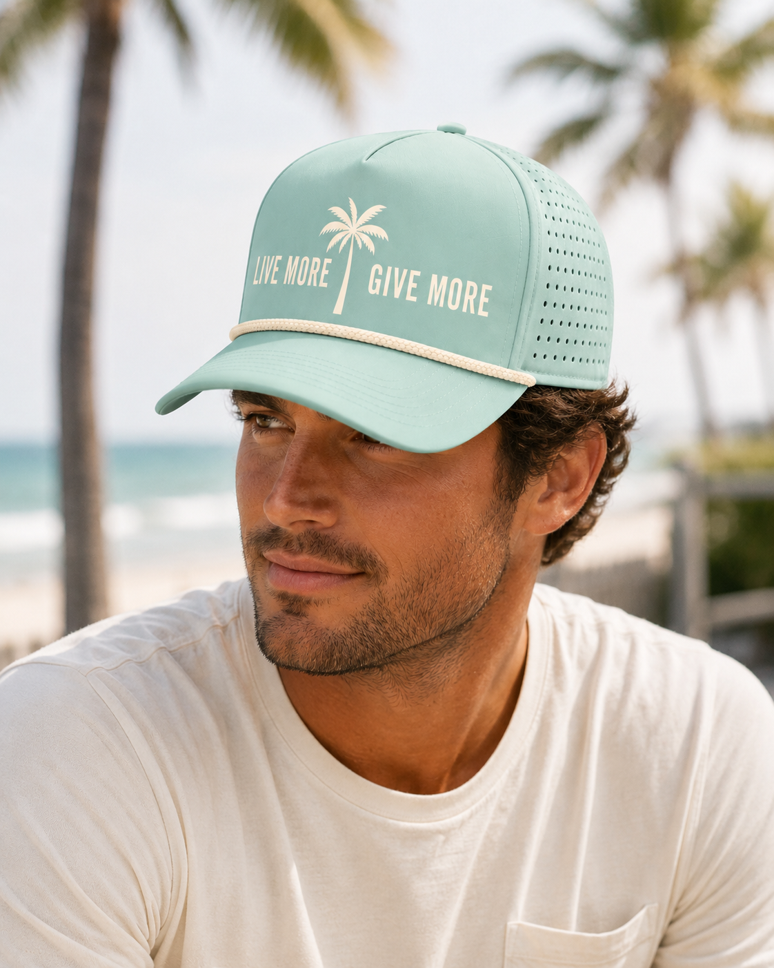 Male model at the beach wearing the KiCares Seafoam palm hat