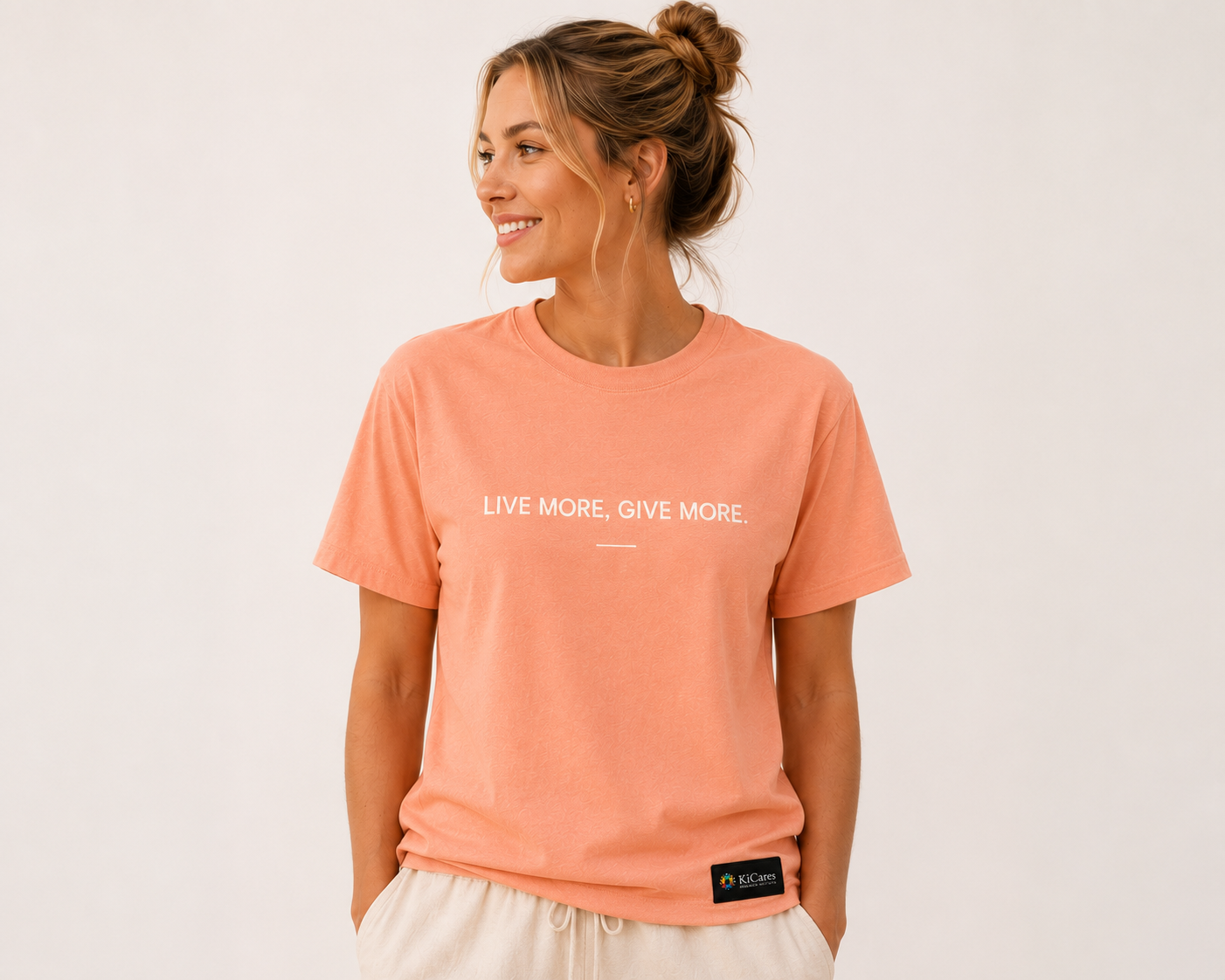 Female model wearing the KiCares Coral tee, front