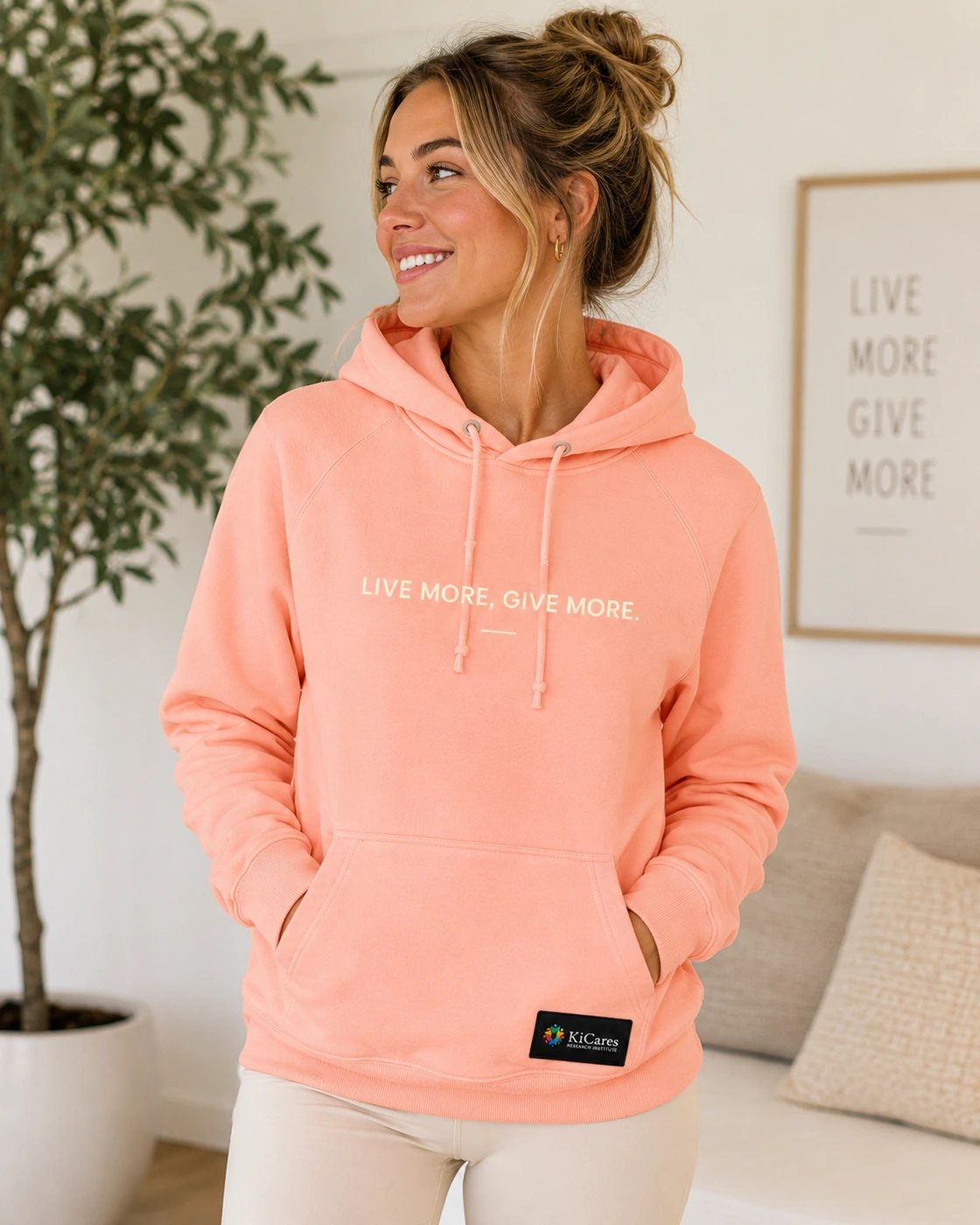 Kihealth hoodie in Coral, female model front