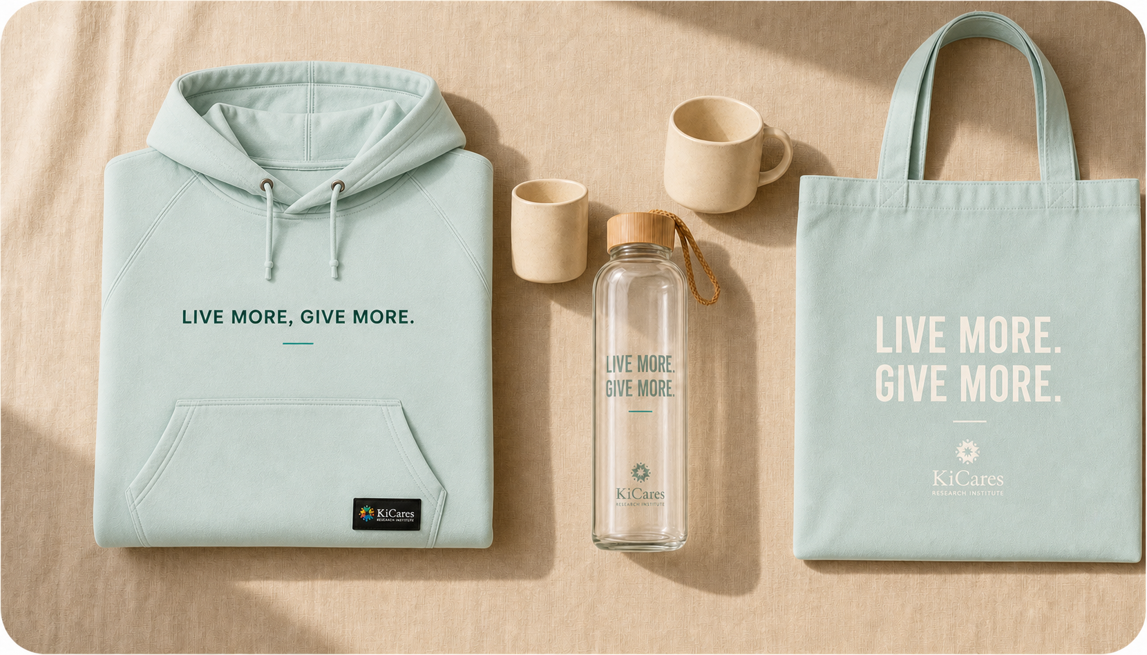 KiCares Live More. Give More. collection — seafoam hoodie, water bottle, mugs, and tote