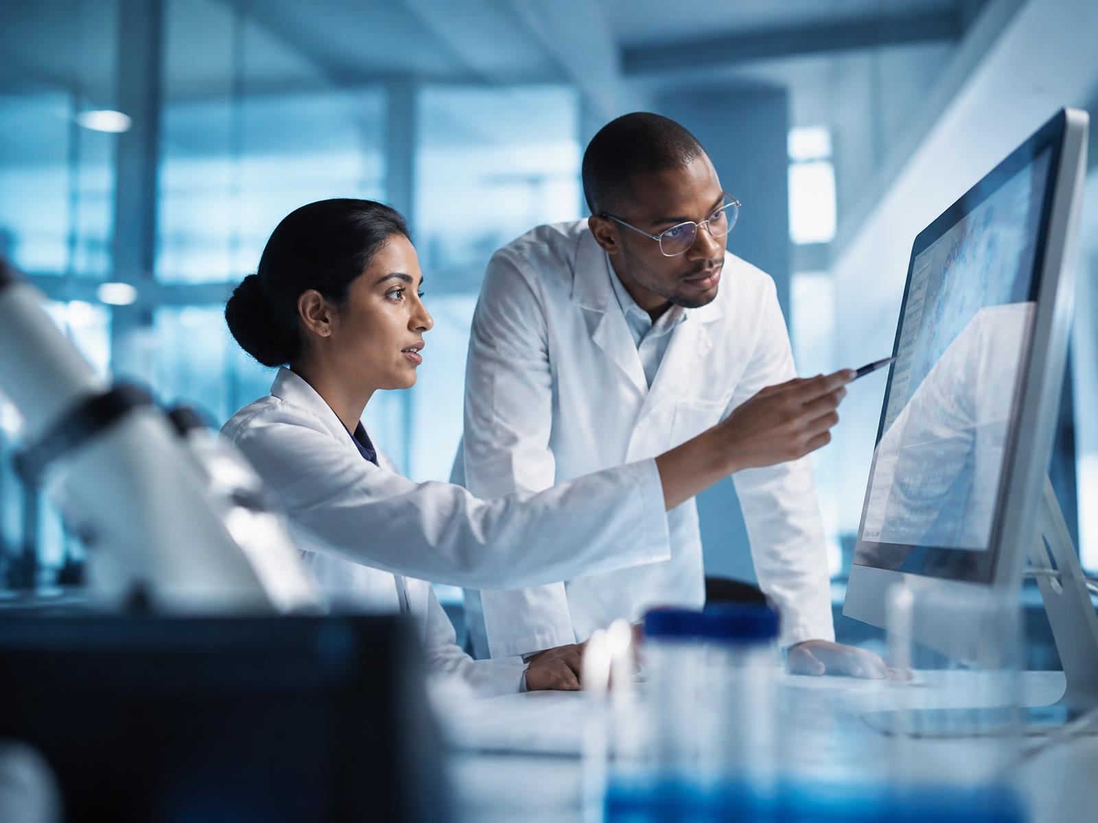 Researchers analyzing biological data together in a modern laboratory